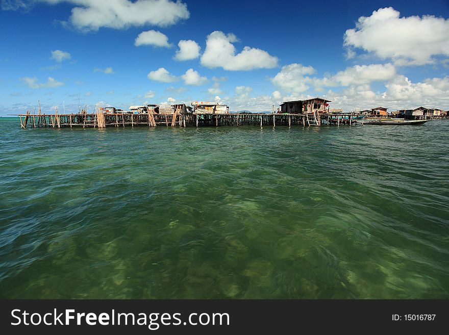 Water Village with deep blue sky, clouds and crystal clear water.