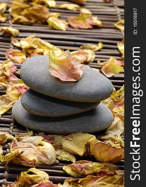 Stack of stone with rose withered petals