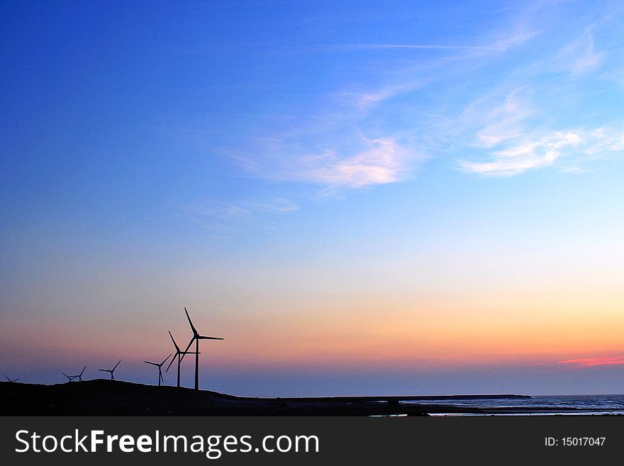 Windmill silhouette with colorful sky at sunset. Windmill silhouette with colorful sky at sunset