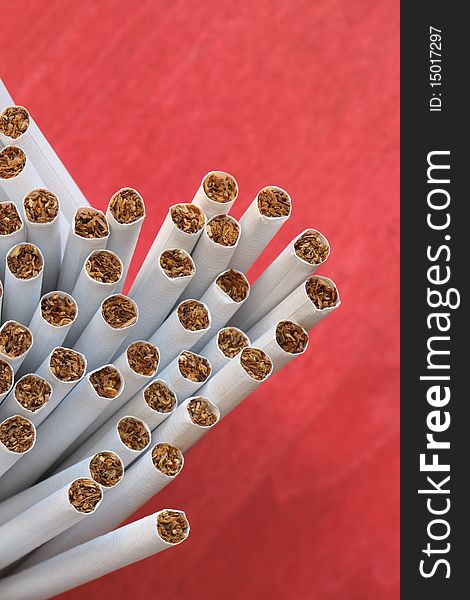 A lot of cigarettes on red background