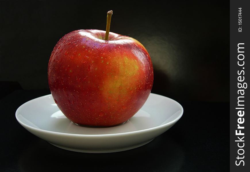 The Red Apple On A White Plate