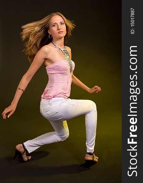 Young woman is dancing in a studio setting. Ideal for young lifestyle themes. Young woman is dancing in a studio setting. Ideal for young lifestyle themes.