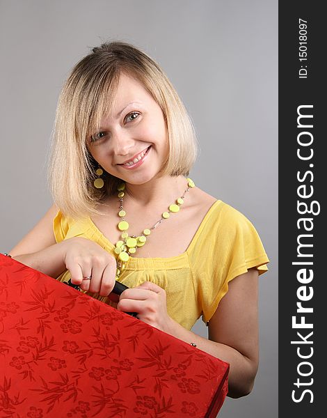 Smiling girl in yellow shirt with red bag