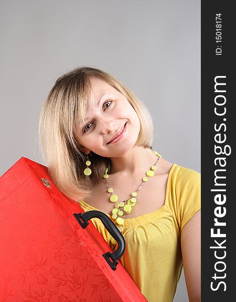 Smiling Girl In Yellow Shirt With Red Bag