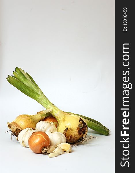 Head of garlic and an onion on a white background.