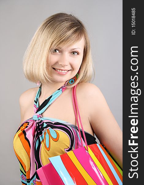 Portrait of girl with striped bag in studio