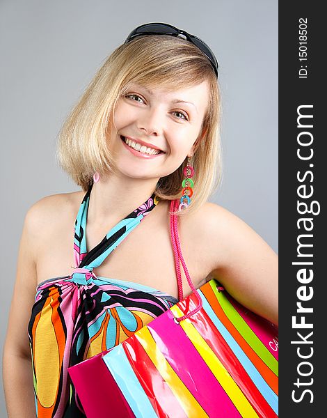 Portrait of girl with striped bag in studio