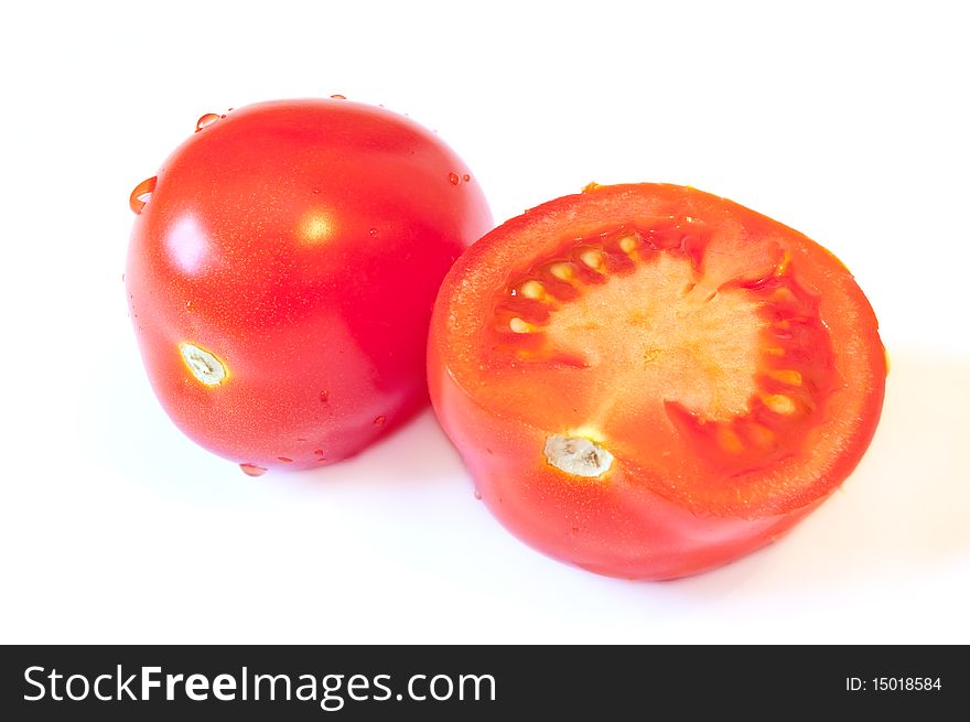 One and a half red tomato with a shadow on a white background