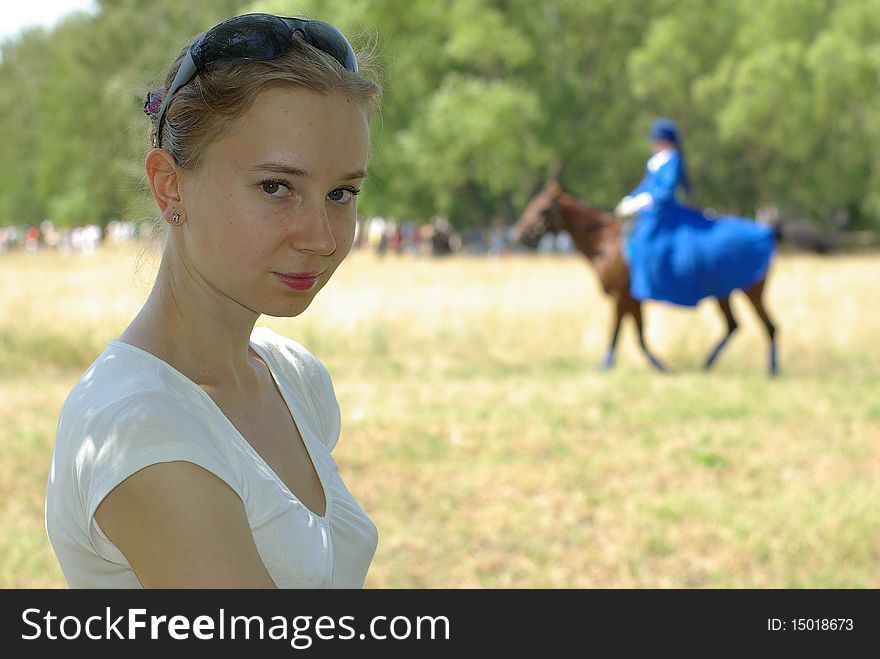 Girl and a horsewoman in the background