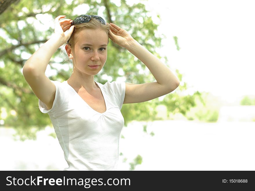 Female in a white t-shirt near the lake