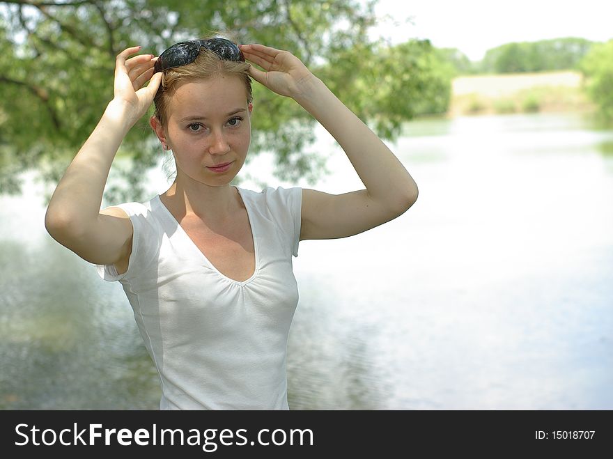 Girl in a white t-shirt near the lake. Girl in a white t-shirt near the lake