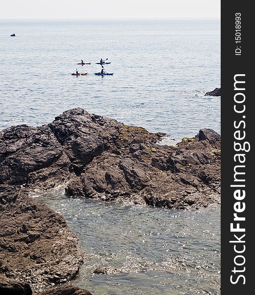 Anglesey coast canoeists in kayaks North Wales. Anglesey coast canoeists in kayaks North Wales