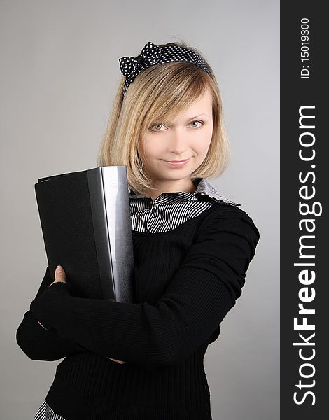 Portrait of business girl with papers in studio over grey