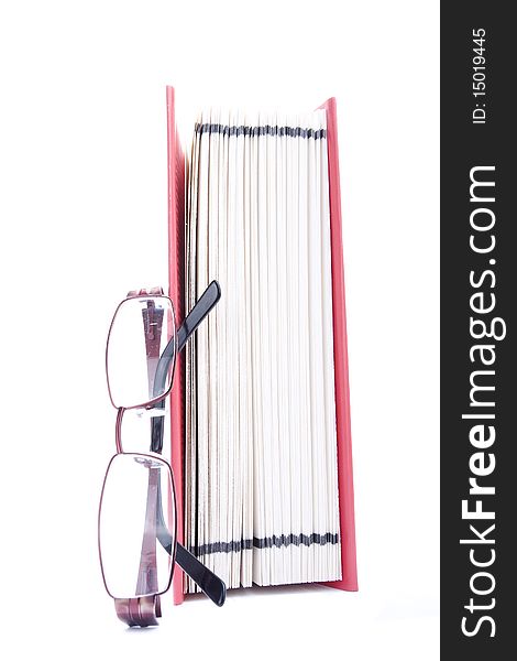Red open book and eyeglasses against white background