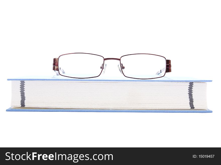 Eyeglasses on the blue book
