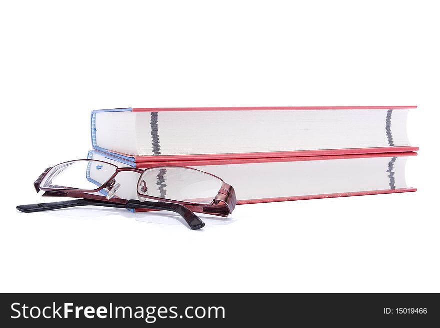 Two books and eyeglasses against white background