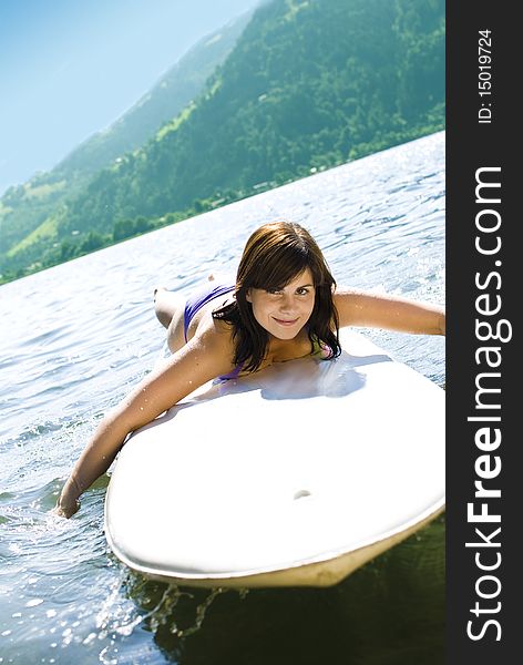 Girl relaxing on surfboard