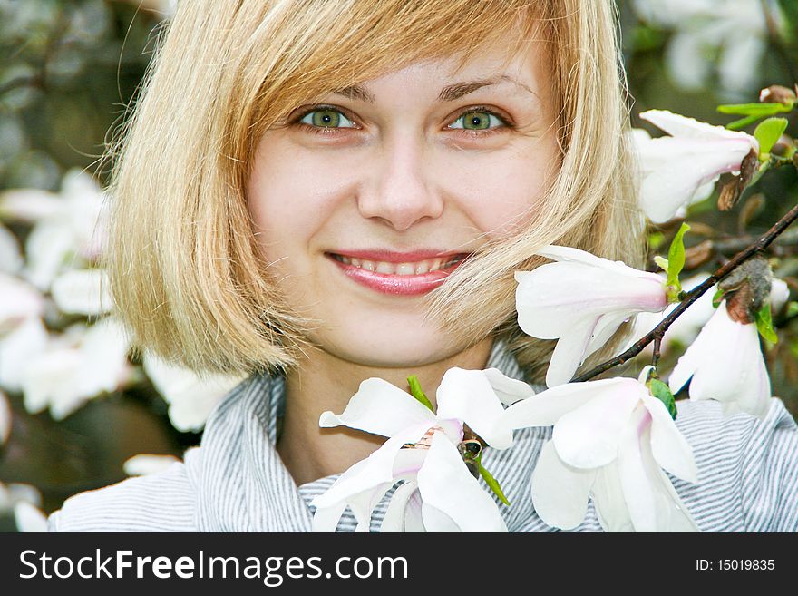 Smiling young girl with magnolia