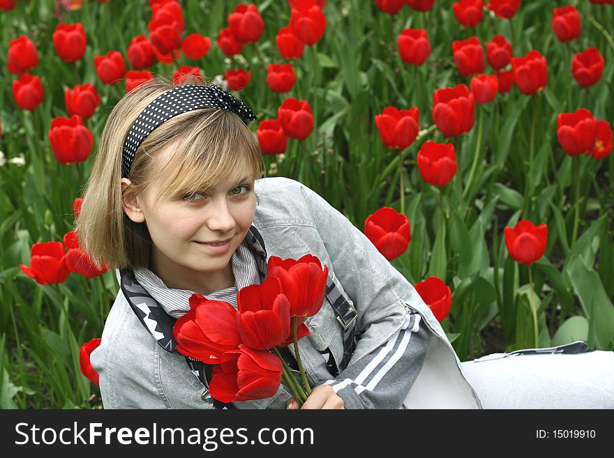 Portrait of girl in red tulips