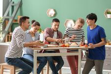 Friends Cooking Together In Kitchen Royalty Free Stock Photography