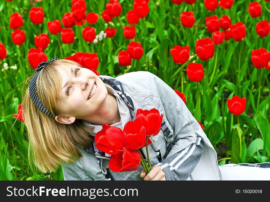 Portrait of girl in red tulips