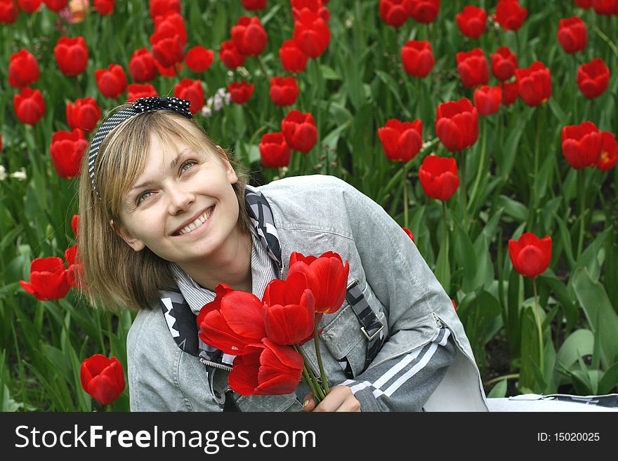 Portrait of girl with red tulips