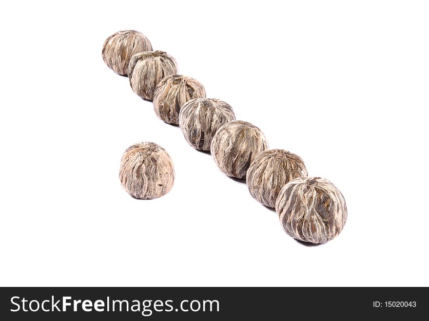 Balls of white tea over white background