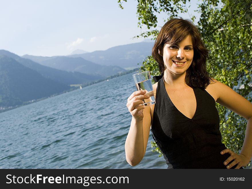 Girl with water glass at the lake of zell am see, austria. Girl with water glass at the lake of zell am see, austria.