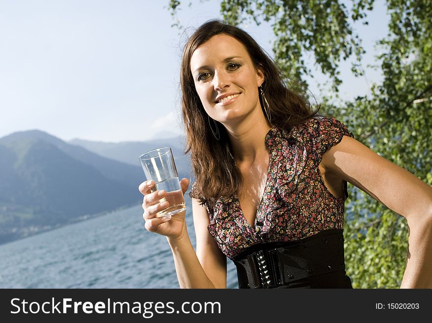 Girl with water glass at the lake of zell am see, austria. Girl with water glass at the lake of zell am see, austria.