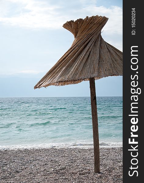 Umbrella invites you to relax on a beach. Umbrella invites you to relax on a beach