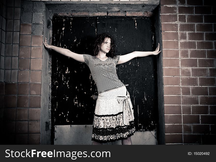 Young woman standing at old doorway. Young woman standing at old doorway