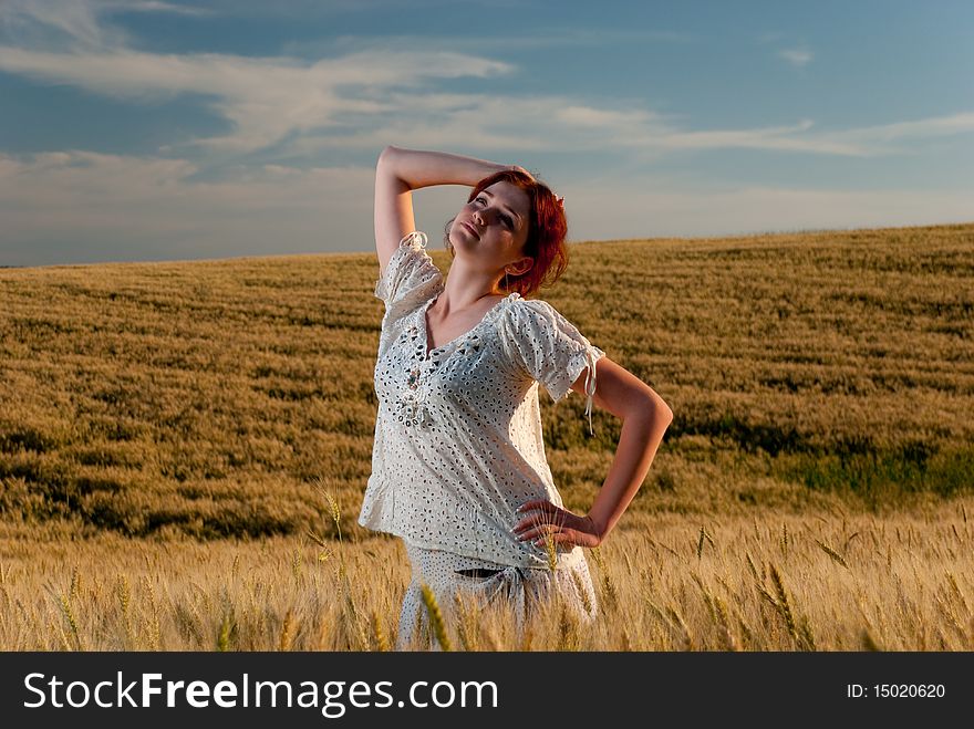 Young redhead woman enjoy at wheat field. Young redhead woman enjoy at wheat field