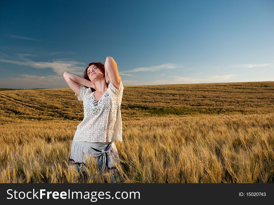 Young woman at wheat