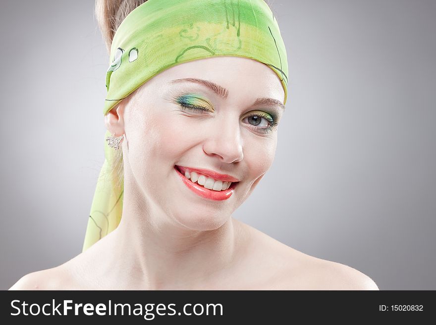 Closeup portrait of smiling winging woman with beautiful green eyes and green bandage on head