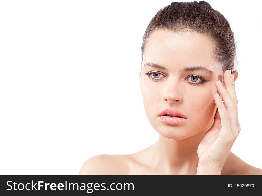 Studio portrait of beautiful young passionate brunette woman touching face with fingers