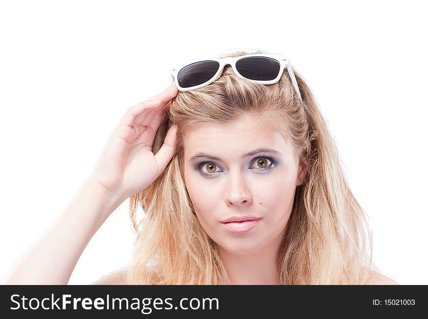 Closeup portrait of beautiful blonde woman holding glasses on head