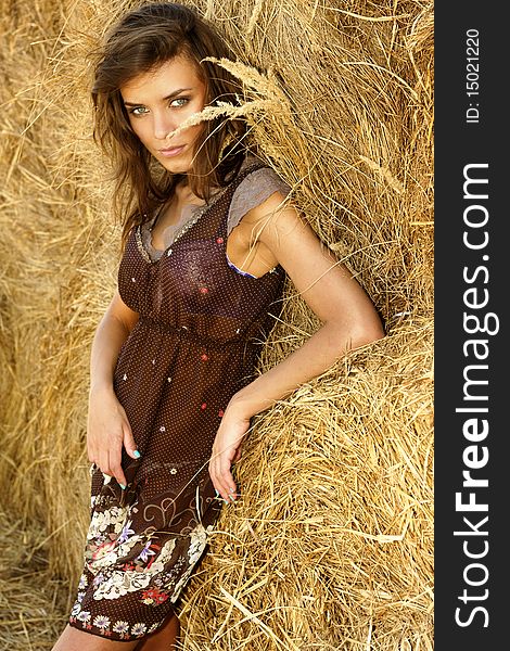 Young attractive woman in a haystack
