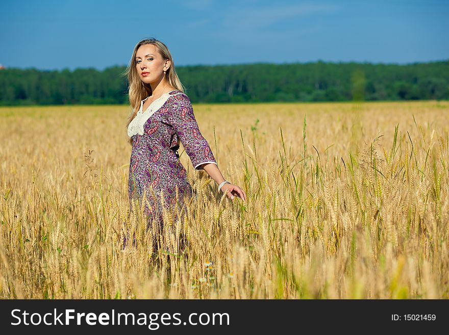 Young beauty girl in the wheat field