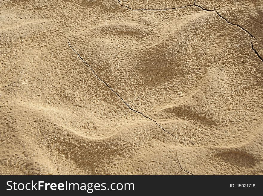 The sand surface.