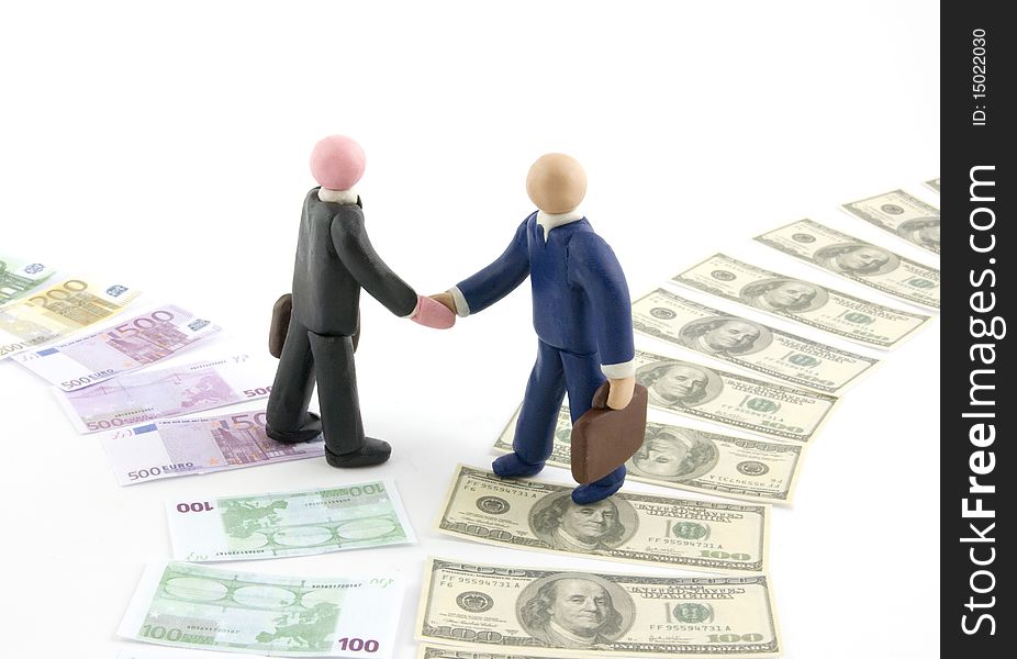 Two businessman figures shaking hands, one coming from Euro path, the other from dollar path. Euro and dollar path are now side by side, a concept of cooperation. Two businessman figures shaking hands, one coming from Euro path, the other from dollar path. Euro and dollar path are now side by side, a concept of cooperation.