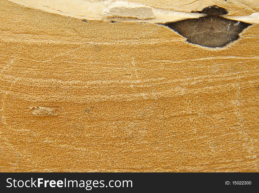 Background of yellow desert stone with obsidian inclusion. Background of yellow desert stone with obsidian inclusion.