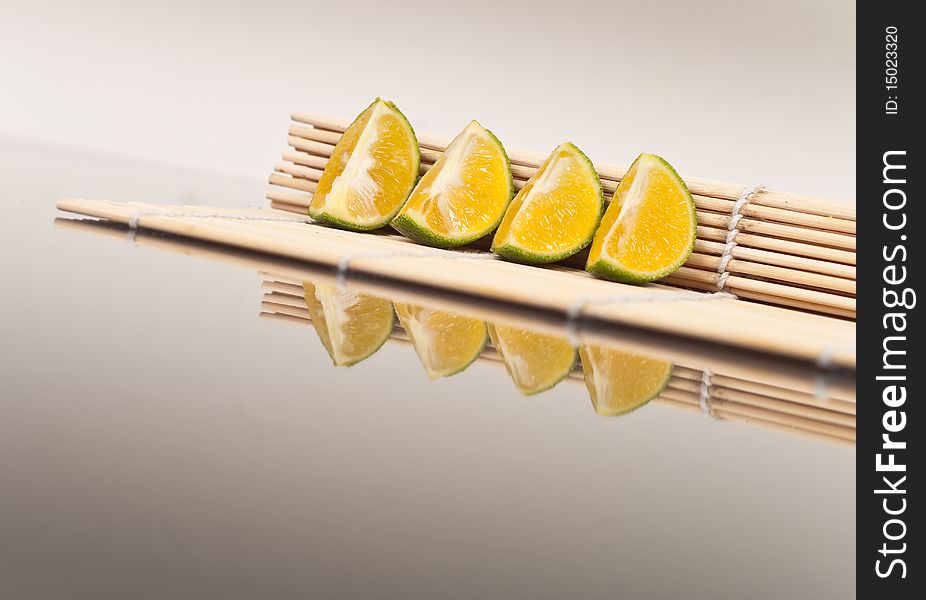 Sliced Limes on Bamboo Mat. Sliced Limes on Bamboo Mat