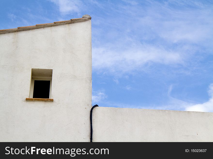 Window of a white house with blue sky