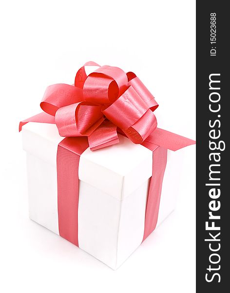 One white gift box with red ribbon and bow isolated
