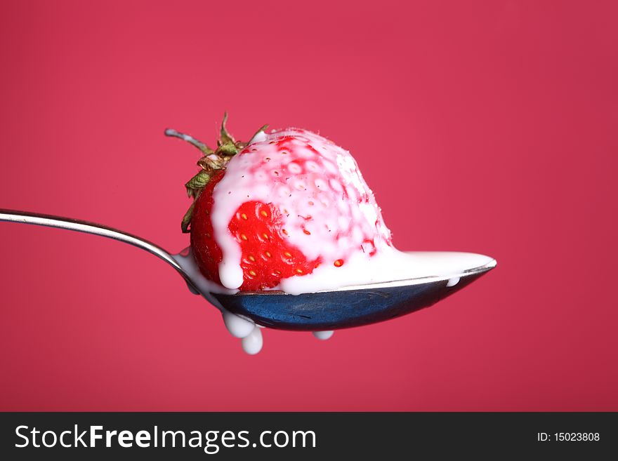 Close-up view of fresh strawberry with cream. Close-up view of fresh strawberry with cream