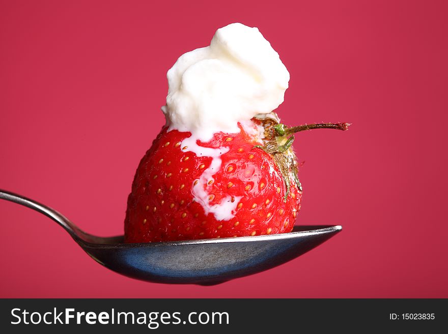 Close-up view of fresh strawberry with cream. Close-up view of fresh strawberry with cream