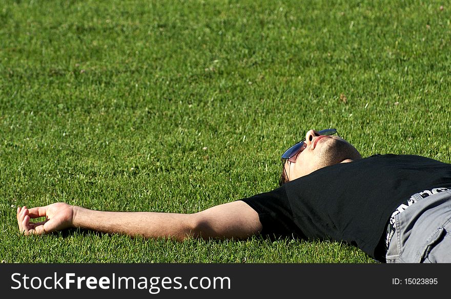 Young man relaxing on field