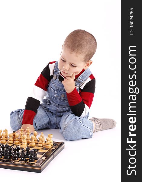 Childre playing with chess in white background, studio shot. Childre playing with chess in white background, studio shot