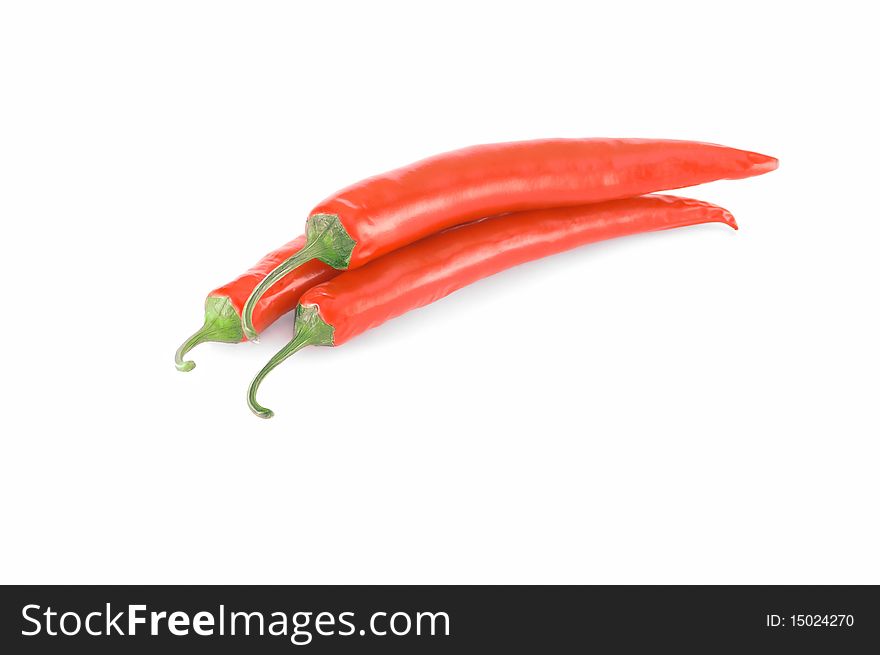 Three isolated red hot chilli peppers