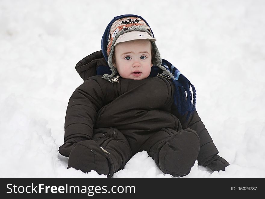 Small child play in cold white snow. Small child play in cold white snow